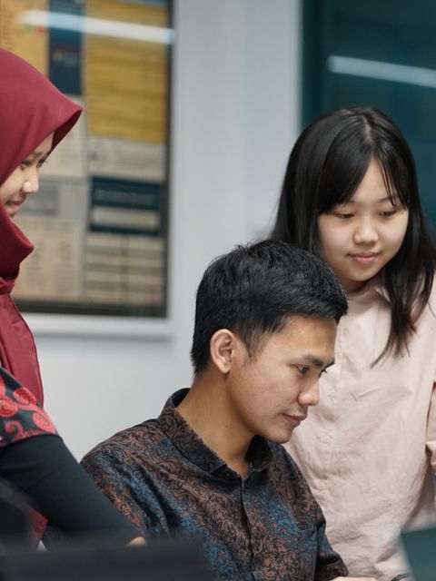 Three team members working through a file together