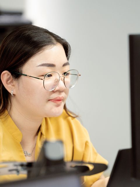 A team member reviewing figures on screen